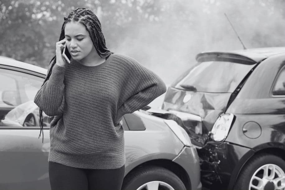 Woman calling for help on the phone after being in a car accident
